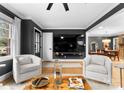 Bright living room features hardwood floors, stylish seating, open access to the dining area, and natural light at 801 Glendora Dr, Charlotte, NC 28212
