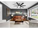 Cozy living room showcasing modern decor, including stylish furniture, unique artwork, and a ceiling fan at 801 Glendora Dr, Charlotte, NC 28212