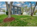 This is an Exterior image of this lovely two-story home with green lawn and tree in the front yard at 8125 Sheringham Way, Charlotte, NC 28227