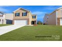 Two-story home showcasing brick accents, neutral siding, well-maintained lawn, and an attached two-car garage at 890 Two Brothers Ln, York, SC 29745