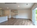 Open-concept space with wood-look floors, ample natural light, leading to a modern kitchen at 890 Two Brothers Ln, York, SC 29745