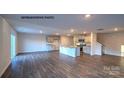 Spacious living area with wood-look floors, kitchen, and staircase, perfect for entertaining at 890 Two Brothers Ln, York, SC 29745