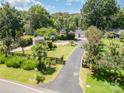 Expansive yard with mature trees and a long driveway, perfect for a serene setting at 9500 Windygap Rd, Charlotte, NC 28278