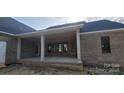 Spacious covered porch with brick surround, offering an ideal spot for outdoor relaxation and entertainment at 1009 Marthas Meadow Ln # 5, Monroe, NC 28112