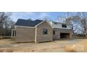 New construction home featuring brick siding, black trim, and an attached garage, blending modern and traditional styles at 1009 Marthas Meadow Ln # 5, Monroe, NC 28112