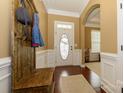 Inviting foyer featuring hardwood floors, half wall wainscoting, and neutral paint at 1022 Bimelech Dr, Indian Trail, NC 28079