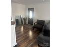 Welcoming living room featuring beautiful wood floors, an entry door, and a comfortable seating area at 1022 Parker St, Monroe, NC 28112