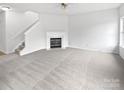 Spacious living room with neutral carpet, fireplace, and plenty of natural light at 10827 Azure Valley Pl, Charlotte, NC 28269