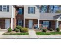Inviting townhouse facade with brick accents, complemented by lush greenery, enhancing curb appeal at 1100 22Nd Ne St # 502, Hickory, NC 28601