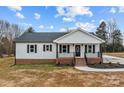 Charming single-story home with a welcoming front porch and well-maintained lawn at 111 Proust Rd, Statesville, NC 28625