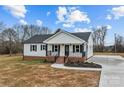Charming single-story home with a welcoming front porch and well-maintained lawn at 111 Proust Rd, Statesville, NC 28625