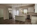 Bright kitchen with a center island, stainless steel appliances, and elegant white cabinetry at 1124 Clouse St, Gastonia, NC 28052