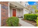 Inviting front entrance with a charming porch, lush greenery, and well-maintained landscaping at 11308 Morgan Valley Ln, Charlotte, NC 28270