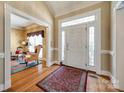 Inviting foyer featuring hardwood floors, a decorative front door, and a view into the living room at 1515 Paul Boyd Rd, Clover, SC 29710