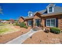 Beautiful brick home featuring a landscaped front yard with a stone walkway and inviting entrance at 1515 Paul Boyd Rd, Clover, SC 29710