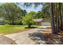 Quaint home with long driveway and large front yard, creating a serene and inviting atmosphere at 2014 Cardinal Loop, Stanley, NC 28164
