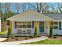 Inviting front porch with stylish seating area, decorative plants, and attractive architectural details at 215 Wyanoke Ave, Charlotte, NC 28205