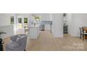 Bright, modern kitchen with stainless steel appliances, center island, and easy access to outdoor living area at 215 Wyanoke Ave, Charlotte, NC 28205