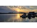 Scenic lake view showcasing the dock with boats parked, under a sunny sky, perfect for waterside enjoyment at 2587 Penngate Dr, Sherrills Ford, NC 28673