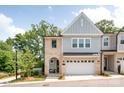 Inviting two-story townhome with brick and siding exterior, attached garage, and a cozy front porch at 3111 Everly Enclave Way, Charlotte, NC 28210