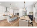 Bright, open-concept kitchen with a large island, stainless steel appliances, and hardwood floors at 3111 Everly Enclave Way, Charlotte, NC 28210
