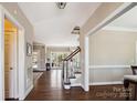 Inviting foyer showcasing hardwood floors, elegant staircase, and seamless transition to living spaces at 420 Woodlark Ct, Indian Trail, NC 28079