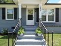 Inviting front porch with steps leading to the entrance and lovely potted plants at 445 Short Hills Dr, Charlotte, NC 28217