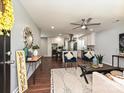 Open-concept living room with hardwood floors, modern furniture, and seamless flow to the kitchen at 445 Short Hills Dr, Charlotte, NC 28217