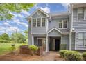 Charming two-story townhome with light gray siding and manicured landscaping provides a welcoming curb appeal at 5301 Amity Springs Dr, Charlotte, NC 28212