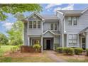 Charming two-story townhome with light gray siding and manicured landscaping provides a welcoming curb appeal at 5301 Amity Springs Dr, Charlotte, NC 28212
