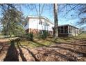 The backyard is spacious, with a brick foundation, and a lovely screened in back porch at 544 Stoneybrook Rd, Statesville, NC 28677