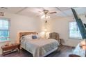 Comfortable bedroom with a ceiling fan, a large bed, and a window for natural light at 5700 Carmel Station Ave, Charlotte, NC 28226
