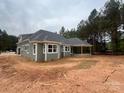 Lovely home featuring shingle siding and a covered porch at 5947 Tipperary Dr, Denver, NC 28037