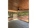 Relaxing screened porch with a ceiling fan and wooded views at 5947 Tipperary Dr, Denver, NC 28037