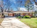 A single story brick home featuring an attached carport and a well-maintained lawn at 601 Wilmar Nw St, Concord, NC 28025