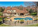 Backyard oasis with a large pool, spa, covered patio, and outdoor entertaining area at 7295 Three Sisters Ln, Concord, NC 28027