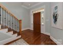 Spacious entryway with hardwood floors, a wooden front door with sidelights, and staircase at 8015 Greenview Terrace Ct, Charlotte, NC 28277