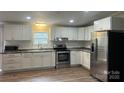 Beautiful updated kitchen with white cabinetry, stainless steel appliances, and modern countertops at 8502 Simpson Rd, Waxhaw, NC 28173