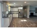 Beautiful kitchen with stainless steel appliances and adjacent living space featuring a fireplace at 8502 Simpson Rd, Waxhaw, NC 28173