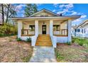 Charming brick home with inviting front porch, classic columns, and neat landscaping at 1132 E Main St, Albemarle, NC 28001