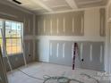 Bedroom with fresh drywall, a large window letting in natural light, and visible electrical outlets at 1259 Willow Grove Ln # 100, York, SC 29745