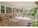 Relaxing covered front porch with stylish decor, cozy seating, and ample natural light for outdoor enjoyment at 1747 Williams Cir, Lancaster, SC 29720