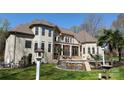 Lovely backyard featuring a pool with waterfall features, palm trees, and elegant outdoor seating areas, perfect for entertaining at 2017 Colorado Ct, Lancaster, SC 29720