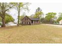 Charming brick home with a well-maintained front yard, featuring mature trees, and a long driveway at 2220 Ross Cauthen Rd, Lancaster, SC 29720