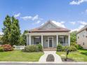 Inviting one-story home featuring a covered front porch with columns, lush landscaping, and a manicured lawn at 4148 Cedar Point Ave, Matthews, NC 28104