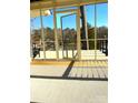 Inviting screened-in porch with a water view and a door to a private retreat at 141 Sunrise Pt, New London, NC 28127