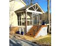 Lovely screened-in porch with wooden steps, railing, and serene outdoor views at 141 Sunrise Pt, New London, NC 28127