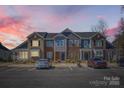 Exterior view of townhomes with parking and landscaping at dusk at 1111 Johns Walk Way, Belmont, NC 28012
