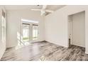 Spacious living room with luxury vinyl plank flooring, modern ceiling fan, and access to the outdoor space at 1111 Johns Walk Way, Belmont, NC 28012