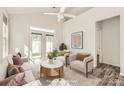 A staged living room with a neutral palette, ceiling fan, and access to the patio at 1111 Johns Walk Way, Belmont, NC 28012